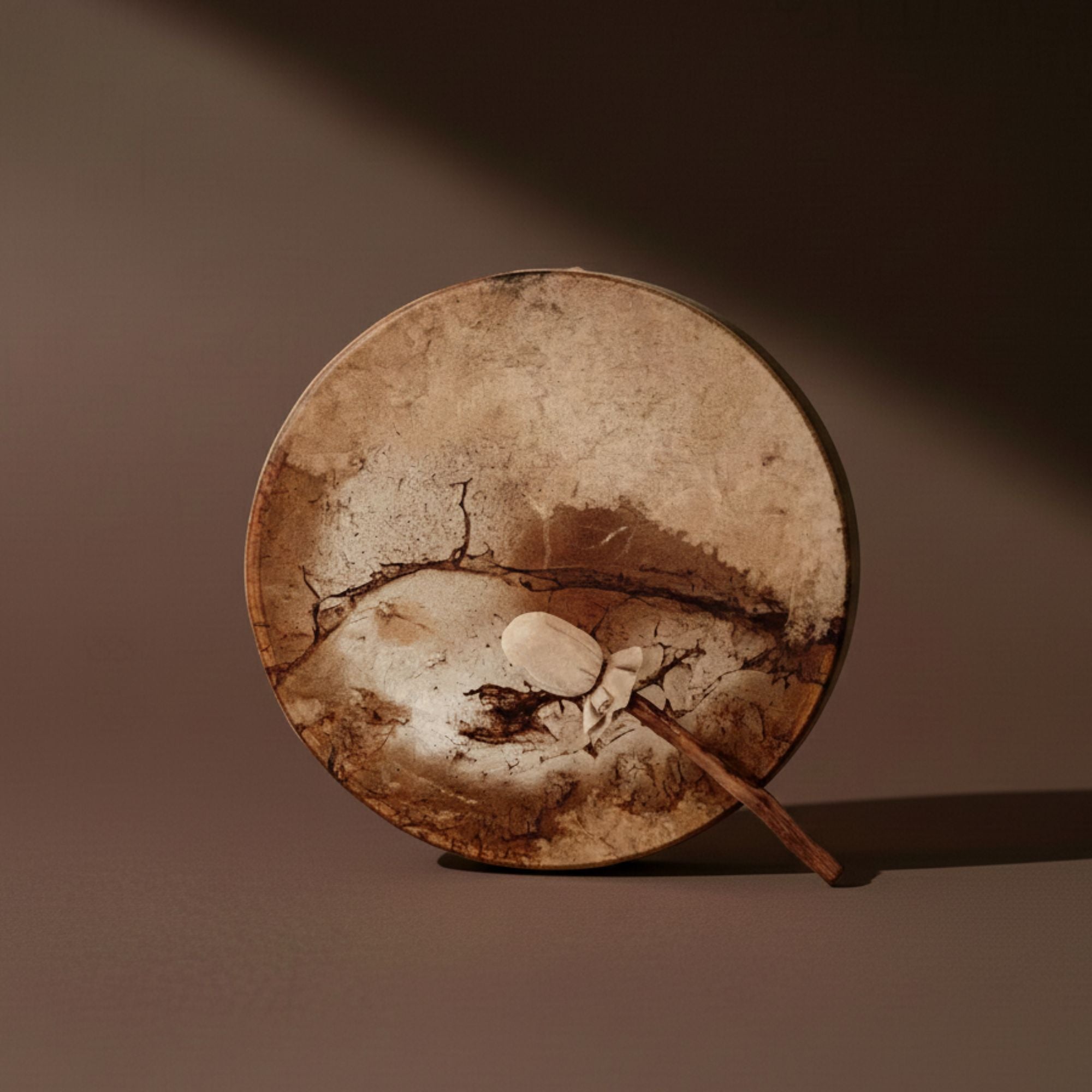 traditional shamanic deer drum hand strung with traditional beater for beating the drum which holds ancient sounds
