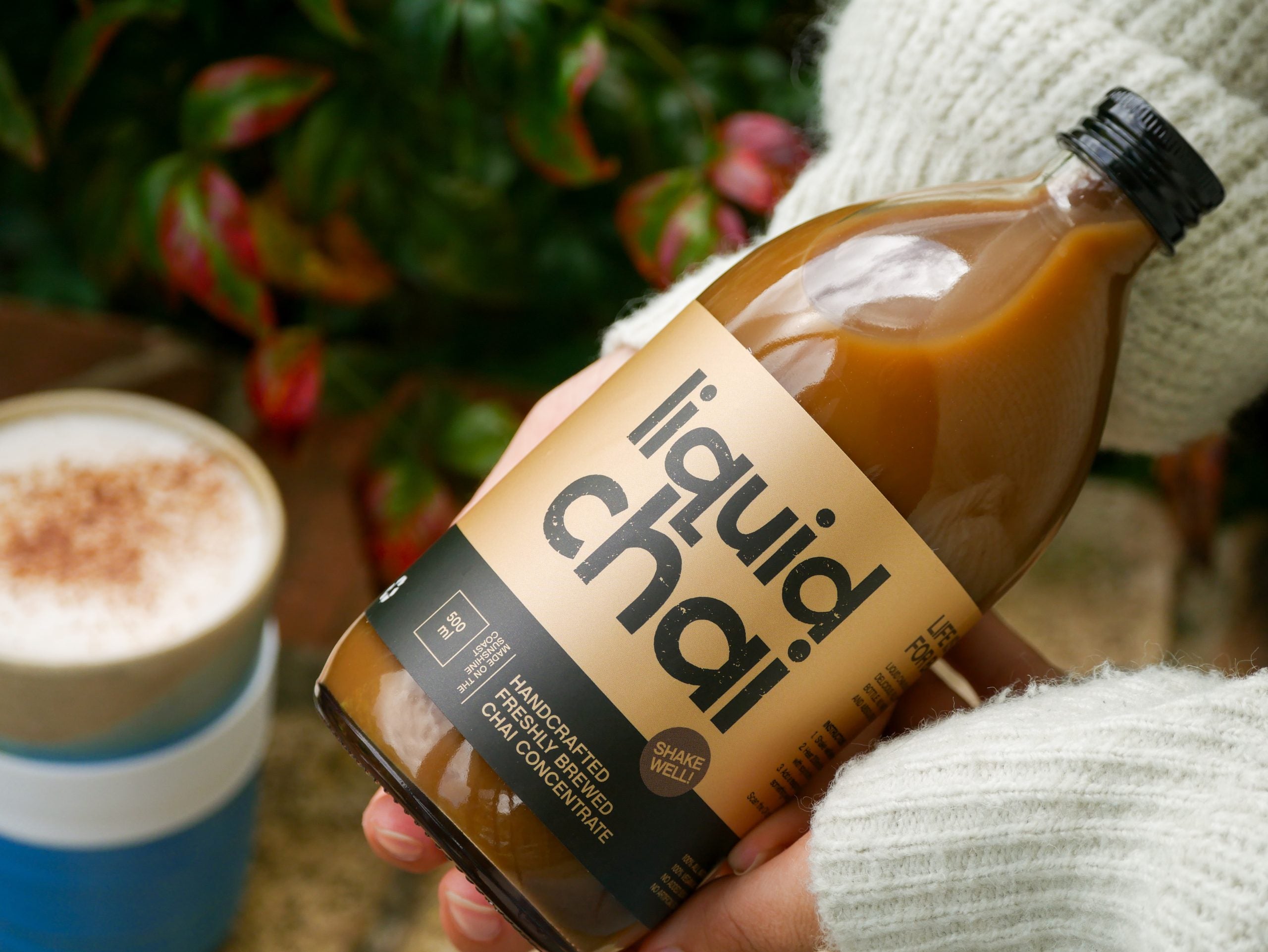 Liquid Chai Original bottle styled with whole spices on linen